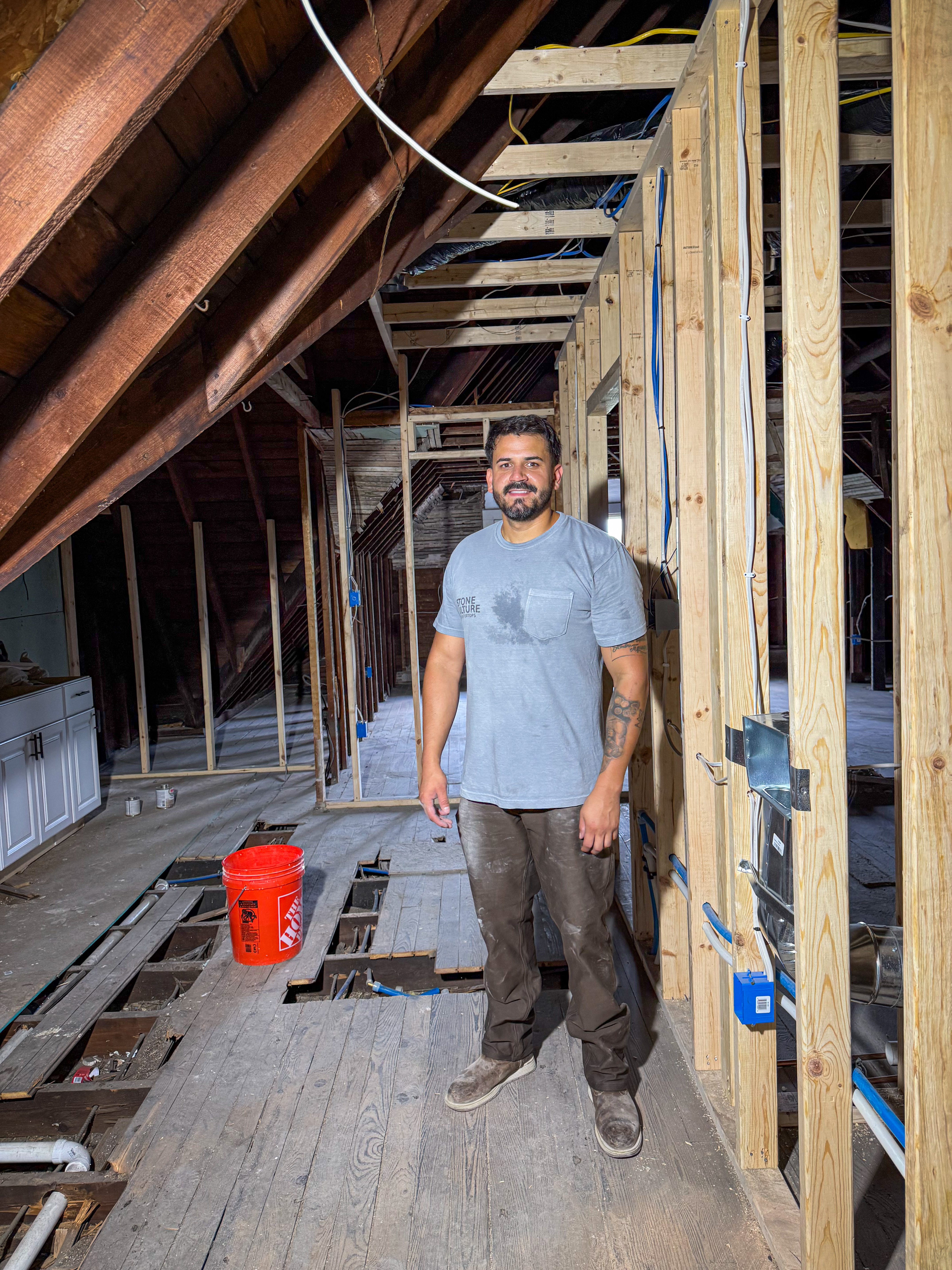 Enrique on a Q&R jobsite with exposed framing